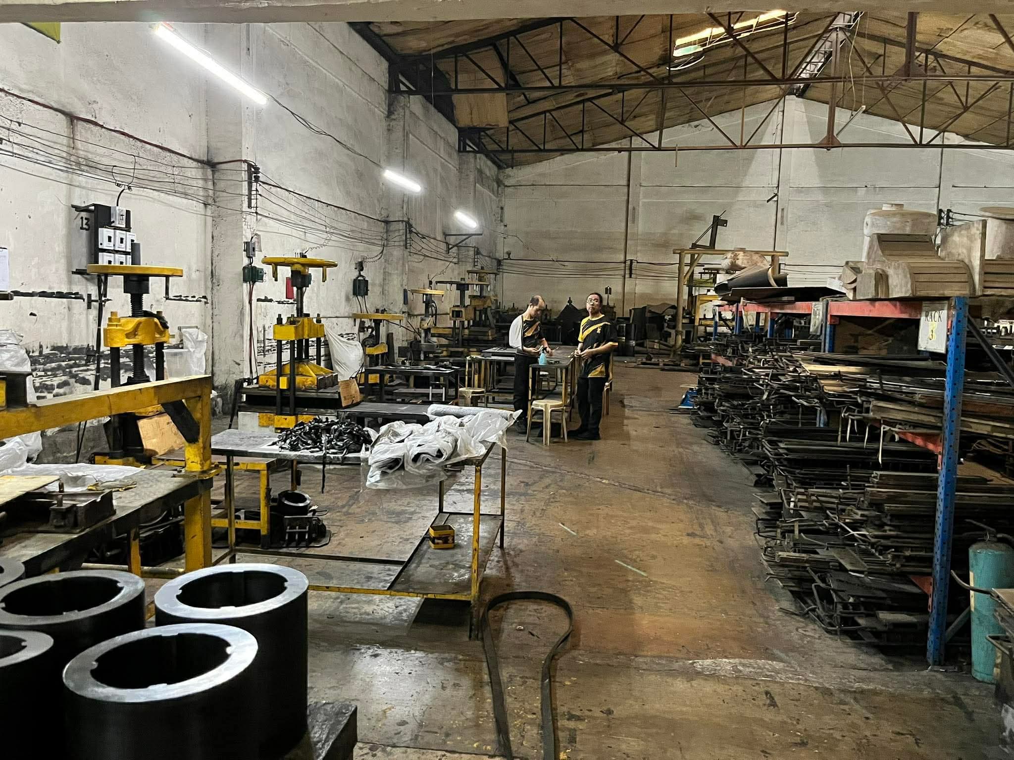 Factory workers operating rubber manufacturing machinery